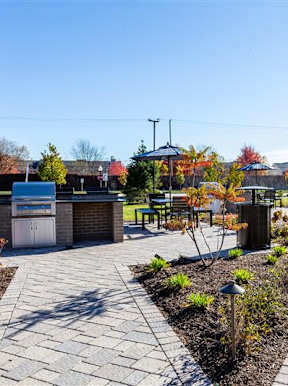 Landscaped outdoor barbecue area at fifty9 Grove Apartments, Naperville, Illinois