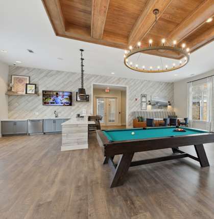 A room with a pool table and a television.