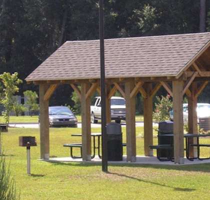 a man sitting on a picnic table in a pavilion