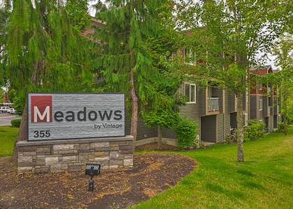 A sign for Meadows by Vintage is in front of a building at  THE MEADOWS BY VINTAGE, Bellingham, WA 98226