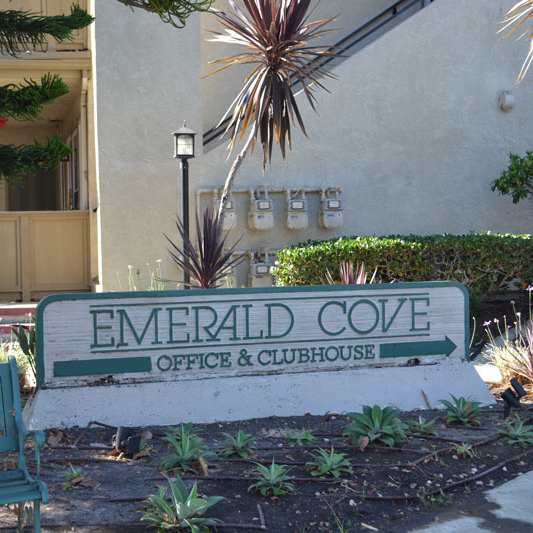 The front of the Mesa Vista Apartments building with a flag flying in the background.