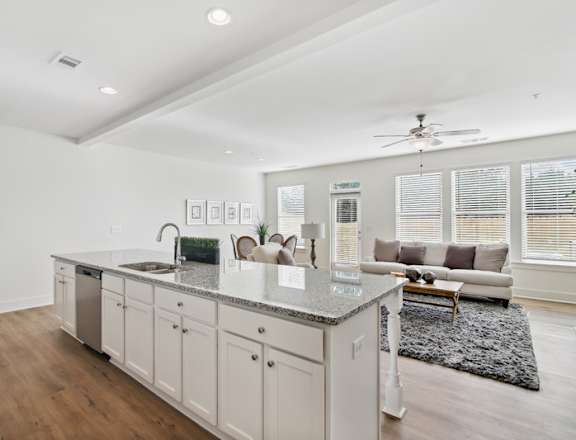 a kitchen with an island and a living room with a couch