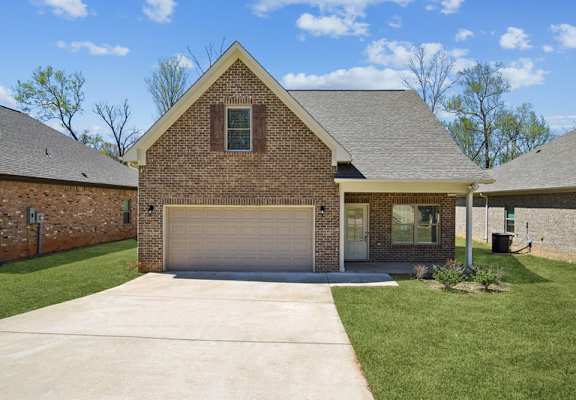 a house with a driveway and a garage door