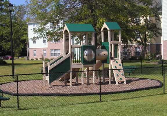 a playground with a slide and other playground equipment
