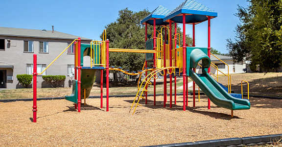 a playground with a swing set and slides