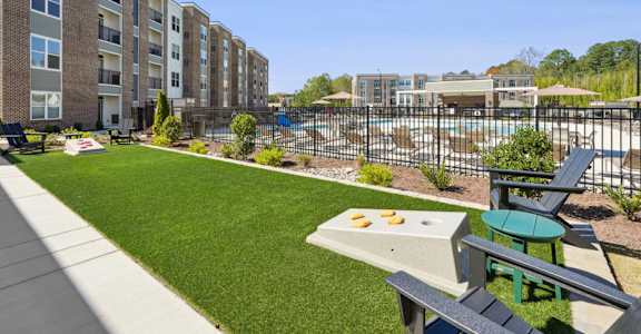 A sunny day at a residential complex with a pool and a picnic table.