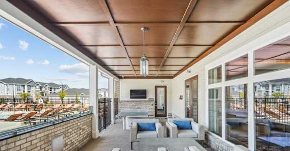 a living room with couches and chairs and a balcony