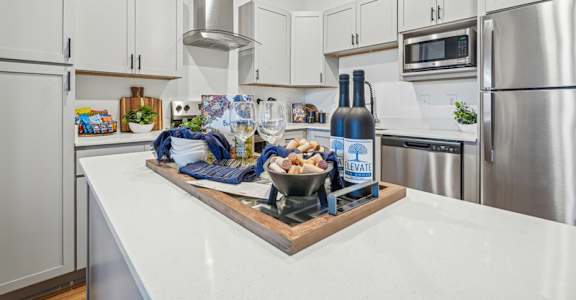 A kitchen with a white countertop and a bottle of elevate on it.