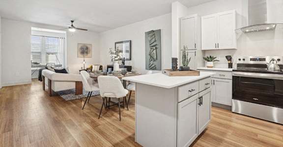A modern kitchen with a dining table and chairs.