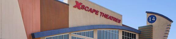 The XScape Theatres building has a red and blue awning.