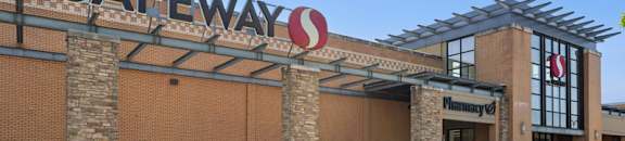 Safeway store with a white truck parked in front.