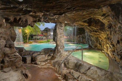 Columbus Luxury Apartments - Hot Tub In An Outdoor Indoor Man-Made Cave. Hot Tub Is Right Next To The Pool With A Waterfall.