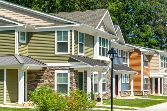 a row of houses with a street light in front of them