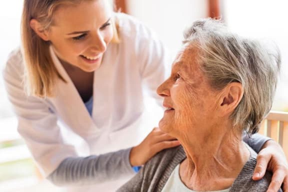 an older woman is being cared for by a young woman
