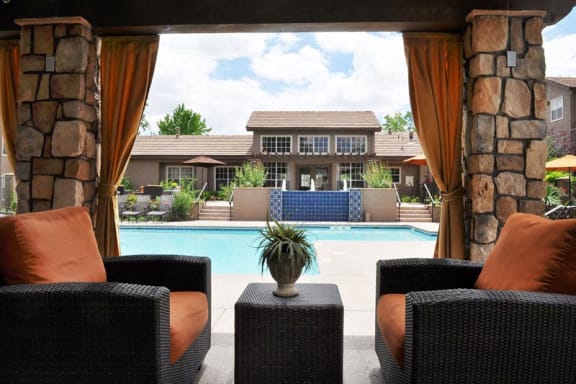 Crystal Clear Swimming Pool with Covered Seating Lounge in ABQ Apartments Near Me 87120