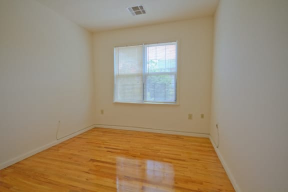 bedroom with white walls and hardwood floors