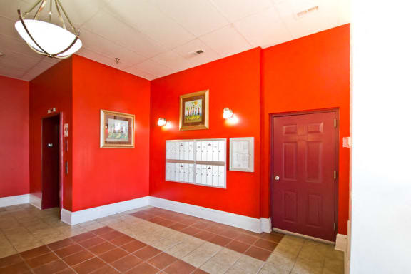 Mail room with red walls and mail boxes