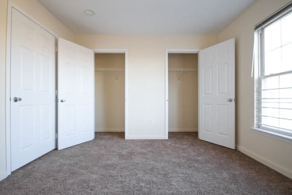 Bedroom with two closets and carpet floors