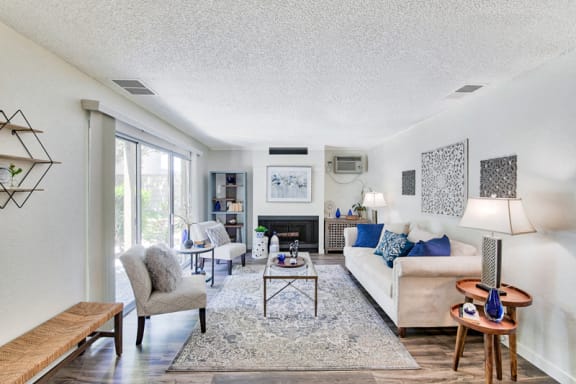 a living room with a couch and chairs and a fireplace  at Mediterranean Village Costa Mesa, Costa Mesa, CA, 92626