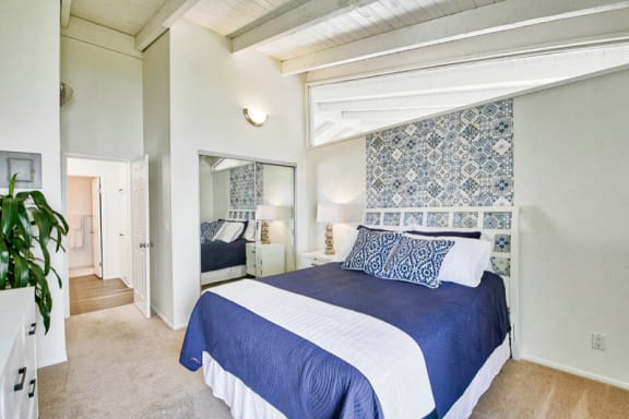 a blue and white bedroom with a bed and a closet  at Mediterranean Village Costa Mesa, Costa Mesa, CA, 92626