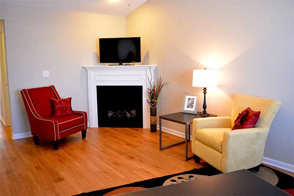 Living room with chairs next to fireplace