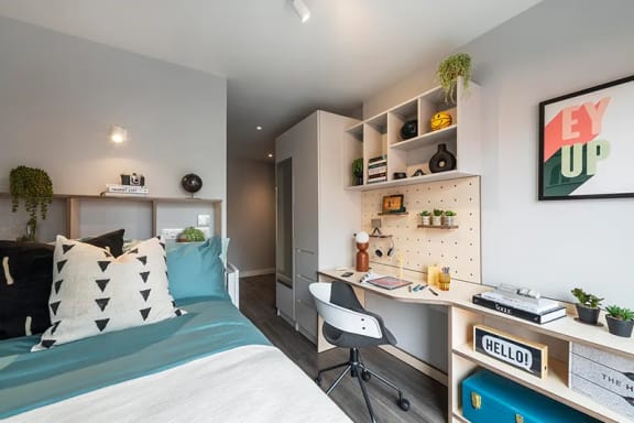 a bedroom with a bed and desk in a 555 waverly unit