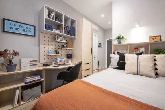 a bedroom with a bed and desk in a 555 waverly unit