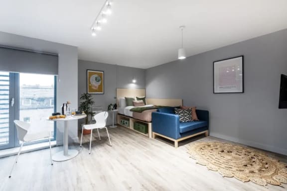 a bedroom with a bed and a table and chairs in a 555 waverly unit