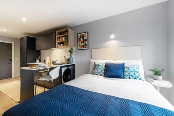 a bedroom with a bed and desk in a 555 waverly unit