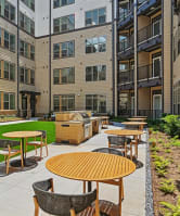 a view from the street of an empty parking lot with an apartment building in the background  at Link Apartments® NODA 36TH,North Carolina,28206