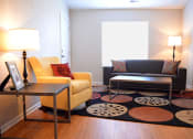 Thumbnail 11 of 22 - Living room with couch, chair, coffee table, sides tables, and two standing lamps
