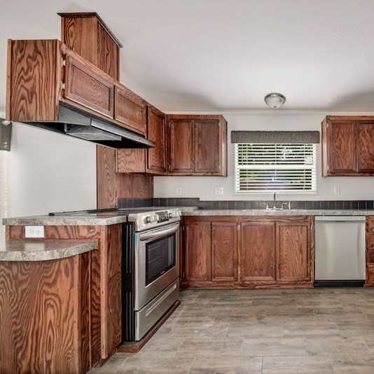 Kitchen with a Refrigerator at Buckingham Village Apartments, Texas, 78148