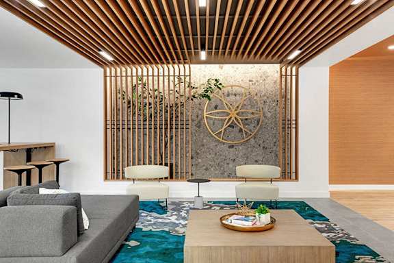 A living room with a grey sofa and a wooden coffee table.