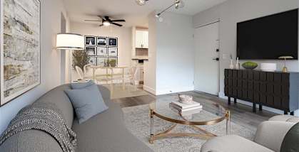 A living room with a grey couch and a coffee table.