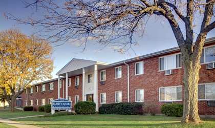 A brick apartment building with a sign in front that says "Bethesda".
