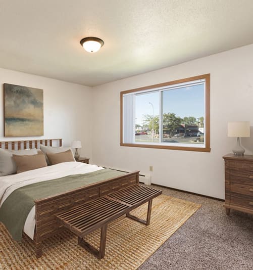 Bismarck, ND Brentwood II |a bedroom with a large bed and a large window