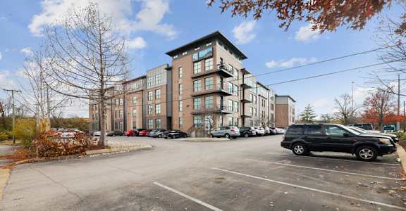 an empty parking lot in front of an apartment building