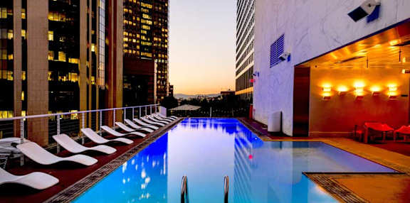 A long rectangular pool with a black pole in the middle.