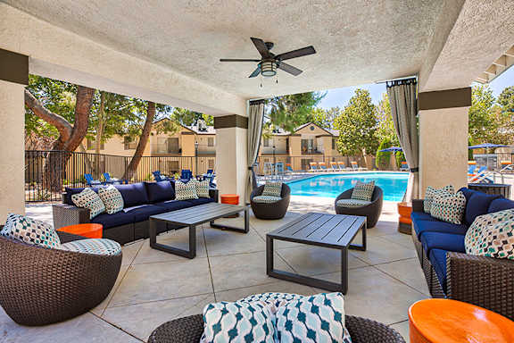 A patio with a pool and furniture.
