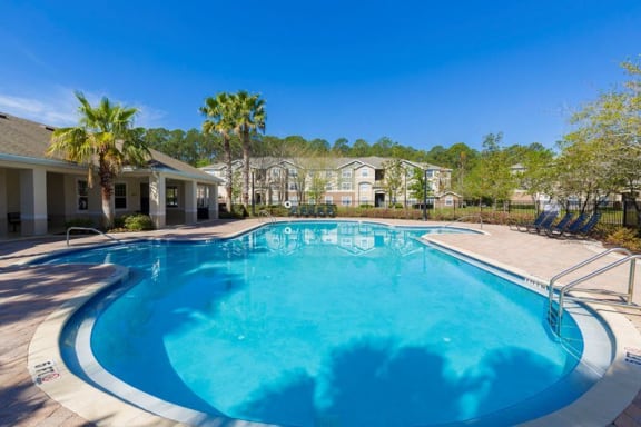 Swimming Pool with Lounge Seating and Clubhouse in the Background