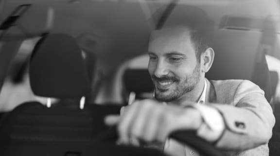 A man is driving a car and is smiling. at Casa Sole Vita Townhomes, Mesa, AZ