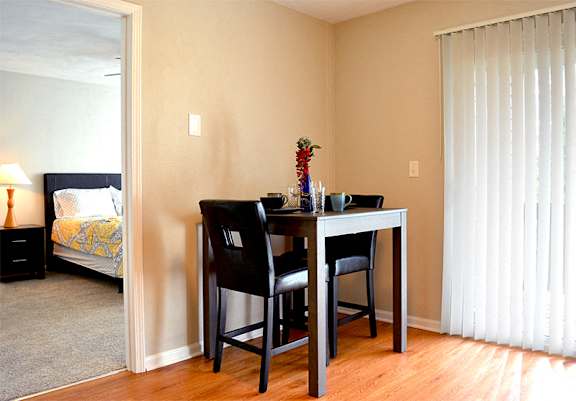 Apartment dining room with dining table seated for two