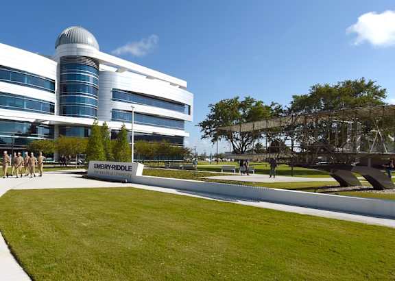 A modern building with a curved glass facade and a white exterior is labeled "Embry-Riddle".