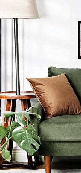 a green couch with yellow and brown pillows in a living room
