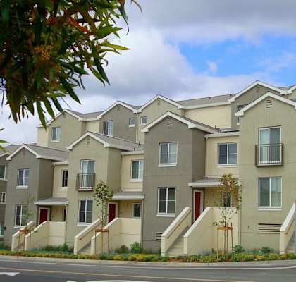 a row of apartment buildings with stairs