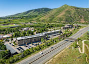 Thumbnail 16 of 26 - A highway with cars driving on it and a mountain in the background.