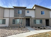 Thumbnail 9 of 10 - A modern two-story house with a grey and beige exterior.