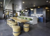 Thumbnail 4 of 7 - a kitchen with a communal table and stools