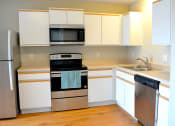 Thumbnail 10 of 22 - Updated kitchen with stainless steel appliances and hardwood flooring