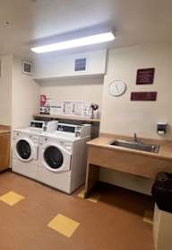 A laundry room with washers and dryers.